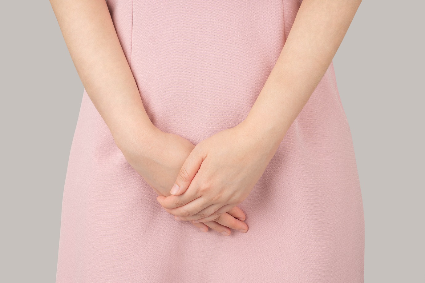 Woman hands holding her crotch suffering from pelvic pain or itc